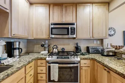 a kitchen with a stove and a microwave at Donner Lake Retreat in Donner Pines Tract
