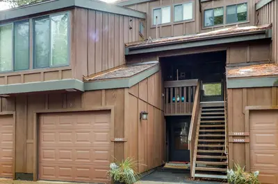 a house with a staircase leading up to the front door at Donner Lake Retreat in Donner Pines Tract