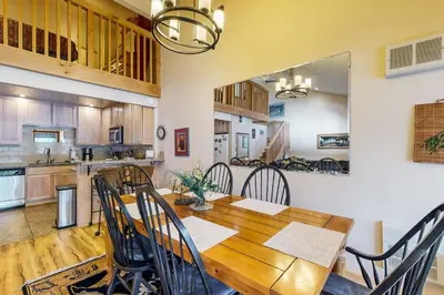 a kitchen and dining room with a wooden table and chairs at Donner Lake Retreat in Donner Pines Tract