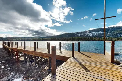 a wooden dock on a lake with a cross on it at Donner Lake Retreat in Donner Pines Tract