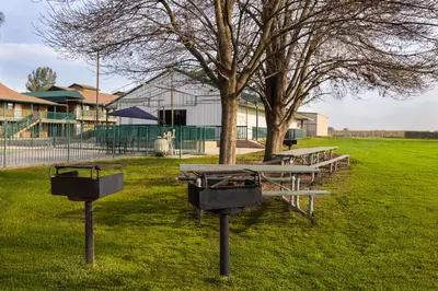 a picnic table and two baskets in a park at Red Lion Inn & Suites Lemoore in Lemoore