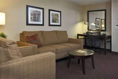 a living room with a couch and a table at Hilton Garden Inn Clovis in Clovis