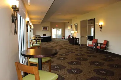 a lobby with a table and chairs and a waiting room at Hilton Garden Inn Clovis in Clovis