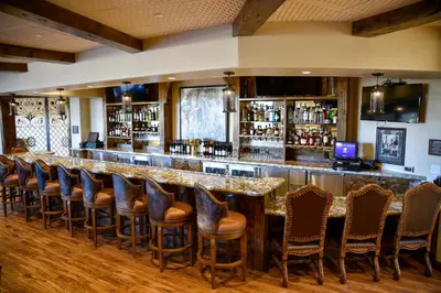 a bar with a bunch of chairs around it at The Murieta Inn and Spa in Rancho Murieta