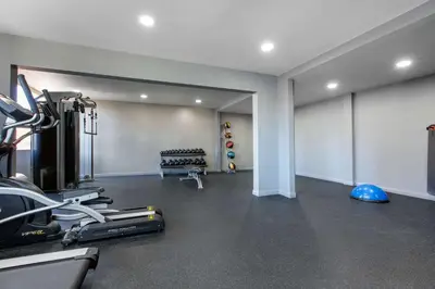 a gym with treadmills and machines in a room at Cielo Hotel Bishop-Mammoth, an Ascend Collection Hotel in Bishop