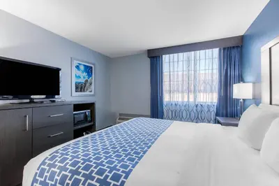 a bedroom with a large bed and a large window at Cielo Hotel Bishop-Mammoth, an Ascend Collection Hotel in Bishop