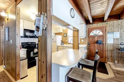 a kitchen with wooden walls and a table and chairs at Picture Perfect Chalet in Prosser Lakeview Estates