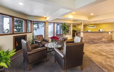 a living room with a fireplace and a table and chairs at WorldMark Lake Tahoe in Stateline