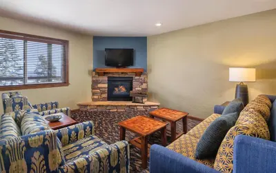 a living room with blue couches and a fireplace at WorldMark Lake Tahoe in Stateline
