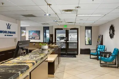 an office lobby with a counter and blue chairs at WorldMark Reno in Reno