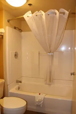 a bathroom with a tub and a toilet and a shower at Days Inn by Wyndham Fresno South in Fresno