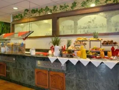 a kitchen with a buffet of food on a counter at Merced Inn & Suites in Merced