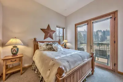 a bedroom with a bed and a large window at Kirkwood Mountain Resort by Vail Resorts in Kirkwood