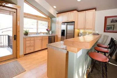 a kitchen with wooden cabinets and a counter top at Kirkwood Mountain Resort by Vail Resorts in Kirkwood