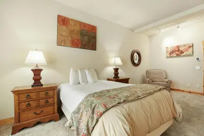 a bedroom with a bed and a chair at Kirkwood Mountain Resort by Vail Resorts in Kirkwood