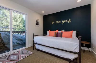 a bedroom with a bed with a black accent wall at Crestview 35 in Mammoth Lakes