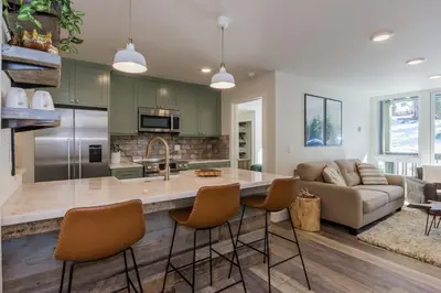 a kitchen with a large island in a living room at Crestview 35 in Mammoth Lakes