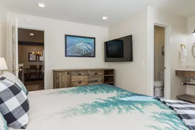 a bedroom with a bed and a television on the wall at Crestview 35 in Mammoth Lakes