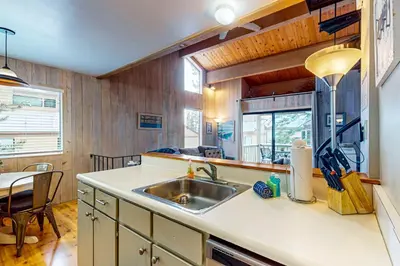 a kitchen with a sink and a table at Beauty by Kings Beach in Wood Vista