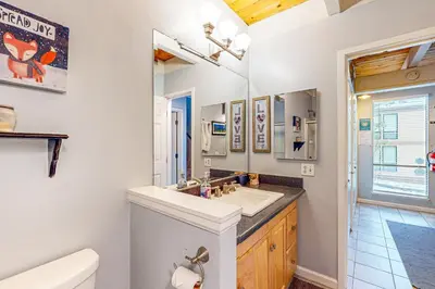 a bathroom with a sink and a toilet and a mirror at Beauty by Kings Beach in Wood Vista