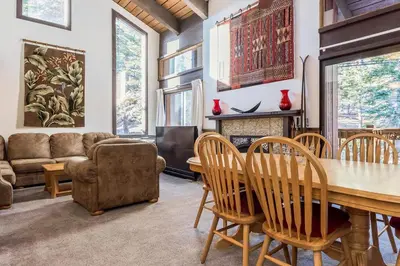 a living room with a table and chairs and a couch at Mammoth Ski and Racquet 132 in Mammoth Lakes