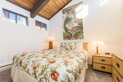 a bedroom with a bed and two windows at Mammoth Ski and Racquet 132 in Mammoth Lakes