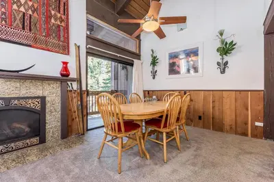 a dining room with a table and chairs and a fireplace at Mammoth Ski and Racquet 132 in Mammoth Lakes