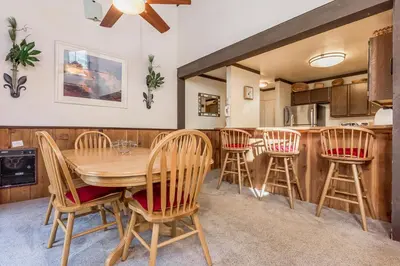 a kitchen and dining room with a wooden table and chairs at Mammoth Ski and Racquet 132 in Mammoth Lakes