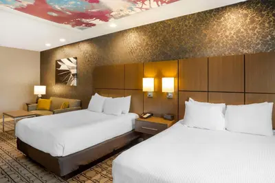 a hotel room with two beds and a couch at Best Western Plus Coalinga Inn in Coalinga