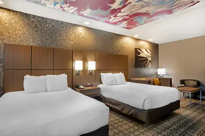 a hotel room with two beds and a desk at Best Western Plus Coalinga Inn in Coalinga