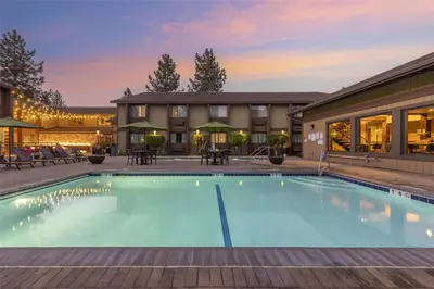 a pool at a hotel with tables and chairs at Best Western Plus Truckee-Tahoe Hotel in Truckee