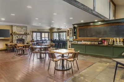 a restaurant with tables and chairs and a chalkboard at Best Western Plus Truckee-Tahoe Hotel in Truckee