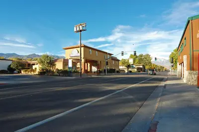 an empty street in a small town with a building at Days Inn by Wyndham Bishop in Bishop