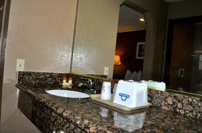a bathroom counter with a sink and a mirror at Days Inn by Wyndham Bishop in Bishop