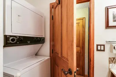 a bathroom with a toilet and a wooden door at Saxon Creek in Mevers