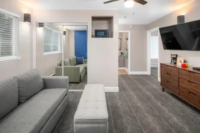 a living room with a couch and a flat screen tv at The Inn at Boatworks, Lake Tahoe in Tahoe City