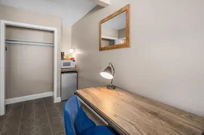 a room with a table with a lamp and a mirror at The Inn at Boatworks, Lake Tahoe in Tahoe City
