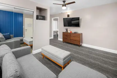 a living room with a couch and a tv at The Inn at Boatworks, Lake Tahoe in Tahoe City