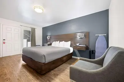 a hotel room with a bed and a couch at Econo Lodge Inn & Suites Heavenly Village Area in South Lake Tahoe