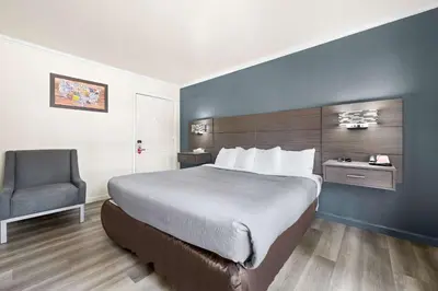a hotel room with a bed and a chair at Econo Lodge Inn & Suites Heavenly Village Area in South Lake Tahoe