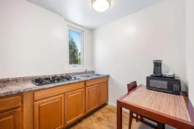 a kitchen with a sink and a table with a microwave at Econo Lodge Inn & Suites Heavenly Village Area in South Lake Tahoe