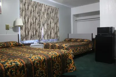 a hotel room with two beds and a curtain at Thunderchief Inn in South Lake Tahoe