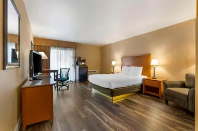a hotel room with a bed and a couch and a television at Best Western Plus Placerville Inn in Placerville