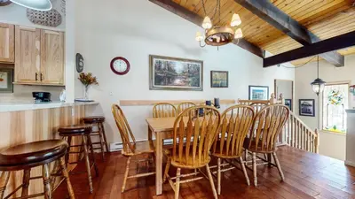 a kitchen and dining room with a table and chairs at Chateau De Montagne #1 Condo in Mammoth Lakes