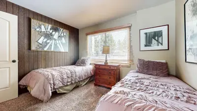 a bedroom with two beds and a window at Chateau De Montagne #1 Condo in Mammoth Lakes