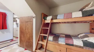 a bedroom with two bunk beds with a ladder at Mammoth West #140 Condo in Mammoth Lakes
