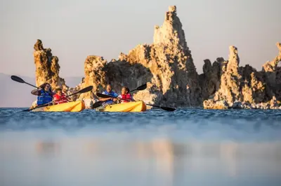 a group of people kayaking on the water near rocks at Chateau De Montagne #15 Condo in Mammoth Lakes