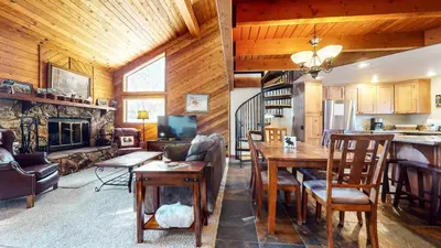 a living room with a dining table and a fireplace at Snowflower #26 Condo in Mammoth Lakes