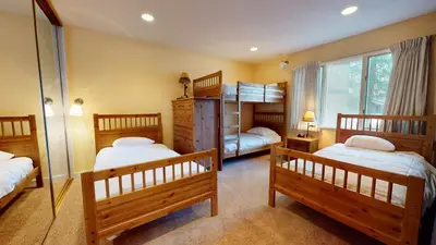 a bedroom with two bunk beds and a window at Chateau De Montagne #23 Condo in Mammoth Lakes