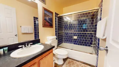 a bathroom with a sink and a toilet and a shower at Chateau De Montagne #23 Condo in Mammoth Lakes